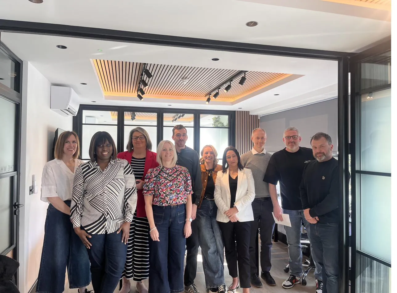 Group photo in a bright meeting room