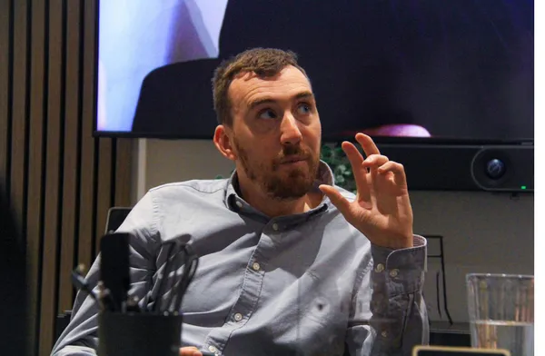A member talking with others around the table
